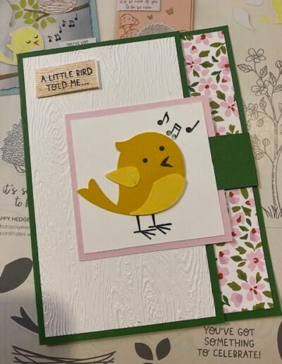 Sweet songbird fun fold card with yellow bird on flap that opens. Flower border inside card shows through