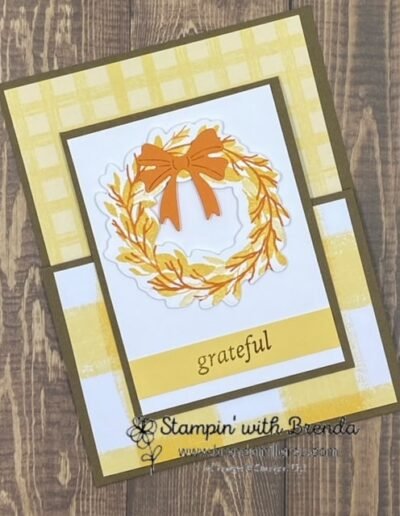 Soft Suede card base with yellow Gingham Cottage DSP and yellow and orange wreath with an orange bow and the word grateful