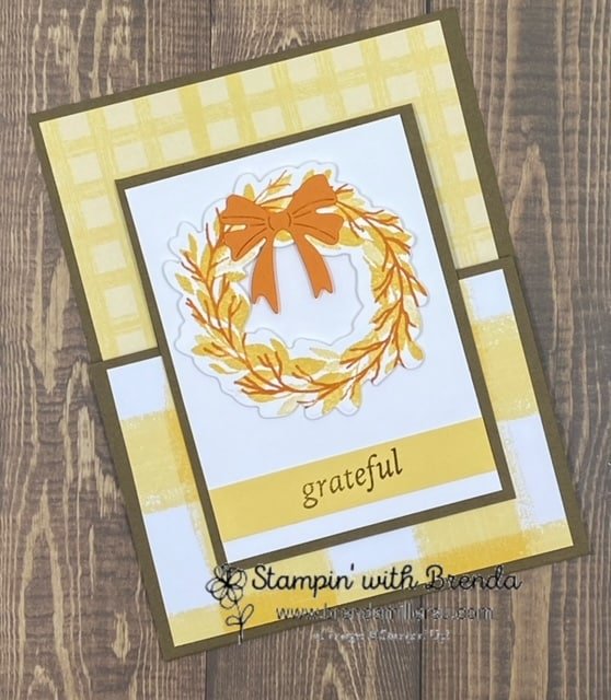 Soft Suede card base with yellow Gingham Cottage DSP and yellow and orange wreath with an orange bow and the word grateful