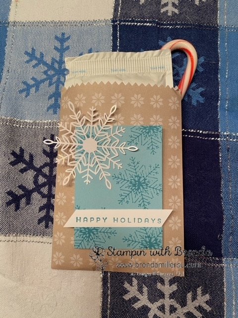 North Pole sack with snowflake tag in blue and white with hot chocolate packet and candy cane