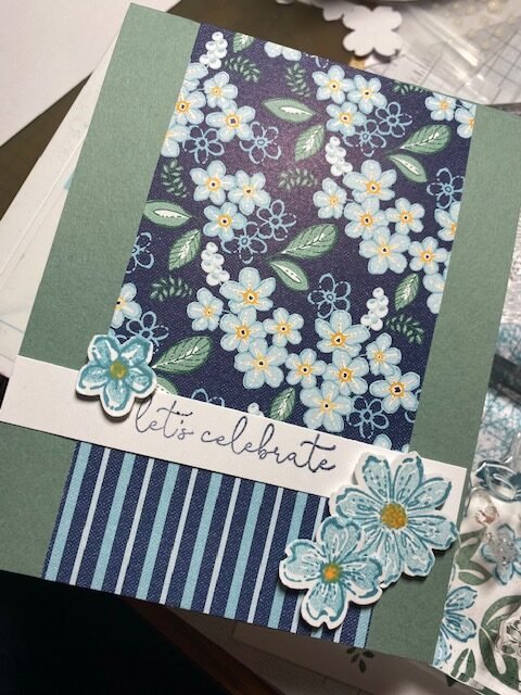 Green and blue card with let's celebrate sentiment and blue Petal Park builder punch flowers
