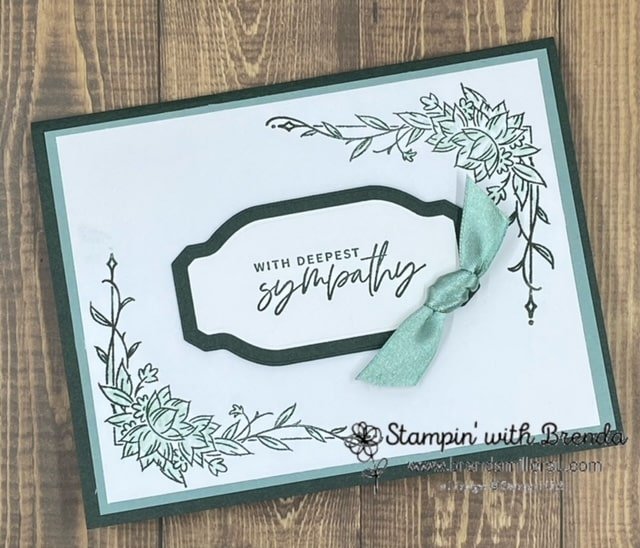 Green and white card with flower borders and sympathy message. Border colored with blender pens, pulling the color in from the stamped image