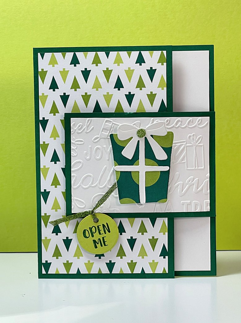 Green & White gift card holder with Merry Bold & Bright DSP. Foldover flap closes the card with a gift box die cut as focal point