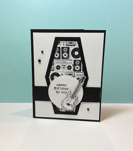 Black and white rock and roll card with hexagon shaped speakers in background and fussy-cut guitar on focal point circle with happy birthday message
