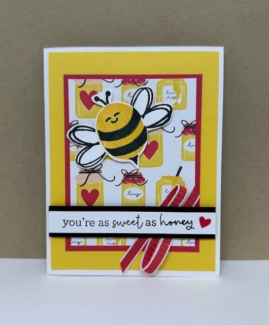 Bee Mine stamp set used to create a bee and mounted on Bee Mine honey pot DSP. Yellow background and "You're as sweet as honey" message for Valentine's Day