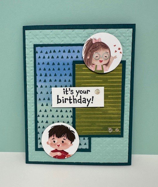 Stampin' Up! Just Kiddin' suite with Just Kiddin' DSP - blues and greens in background and cute kids' faces punched out with circle punch