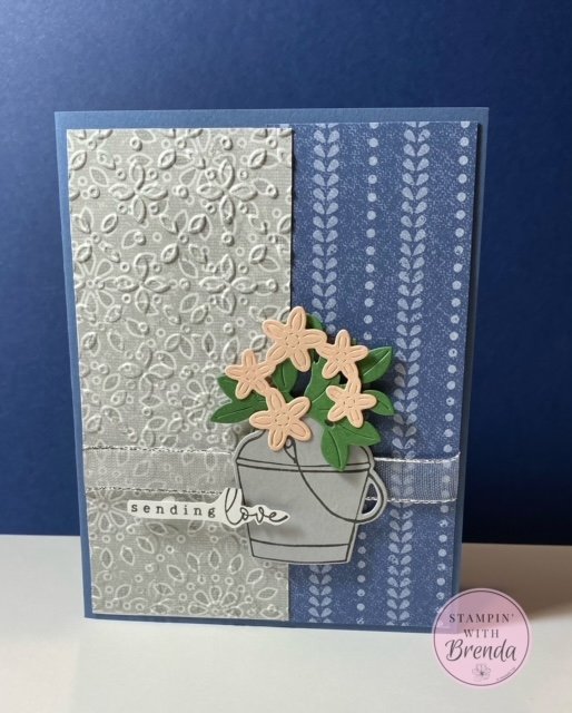 Stampin' Up! Country Lace DSP background embossed with Eyelet folder. Flower can and flowers in green and pink. Sending Love sentiment hand cut