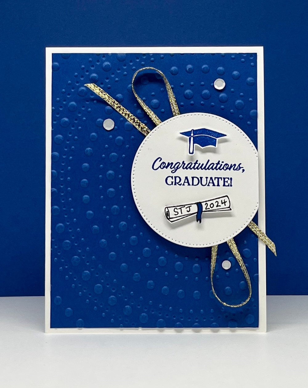 Stampin' Up! graduation card using Cap & Gown stamp set and royal blue background and gold ribbon